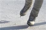 Someones legs with ice skates on